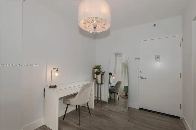 a view of a room with a table and chairs