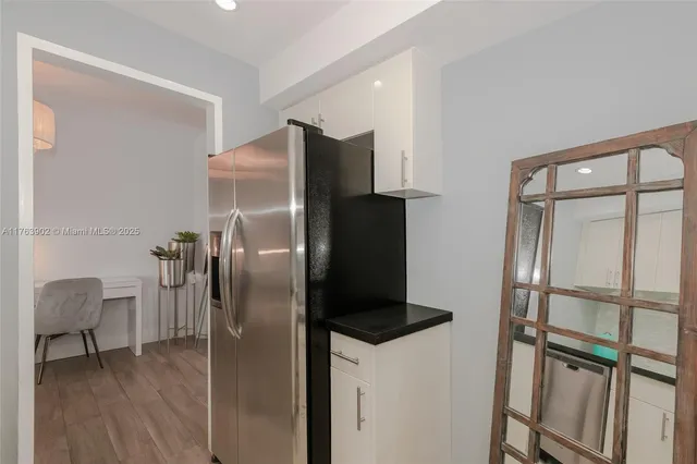 a metallic refrigerator freezer sitting in a kitchen
