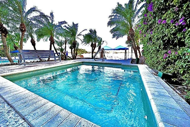 a swimming pool with outdoor seating and yard