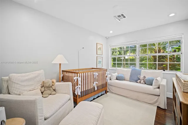 a bedroom with furniture and a large window
