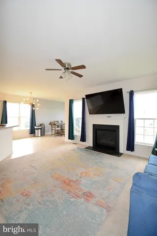 a view of an empty room with a fireplace and a window