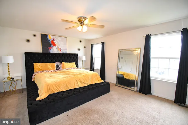 a bedroom with a large bed and a chandelier