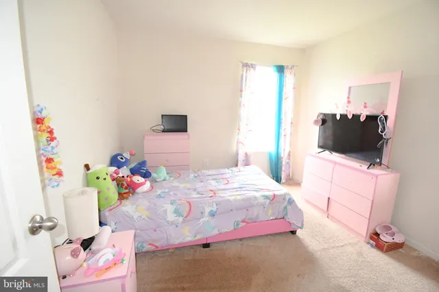 a bedroom with a bed and flat screen tv