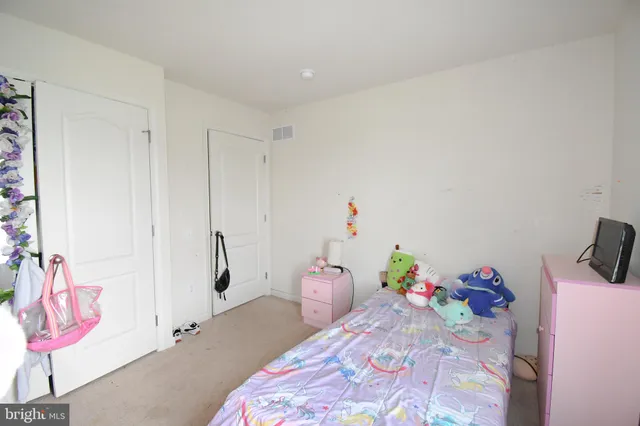 a bedroom with a bed and hallway