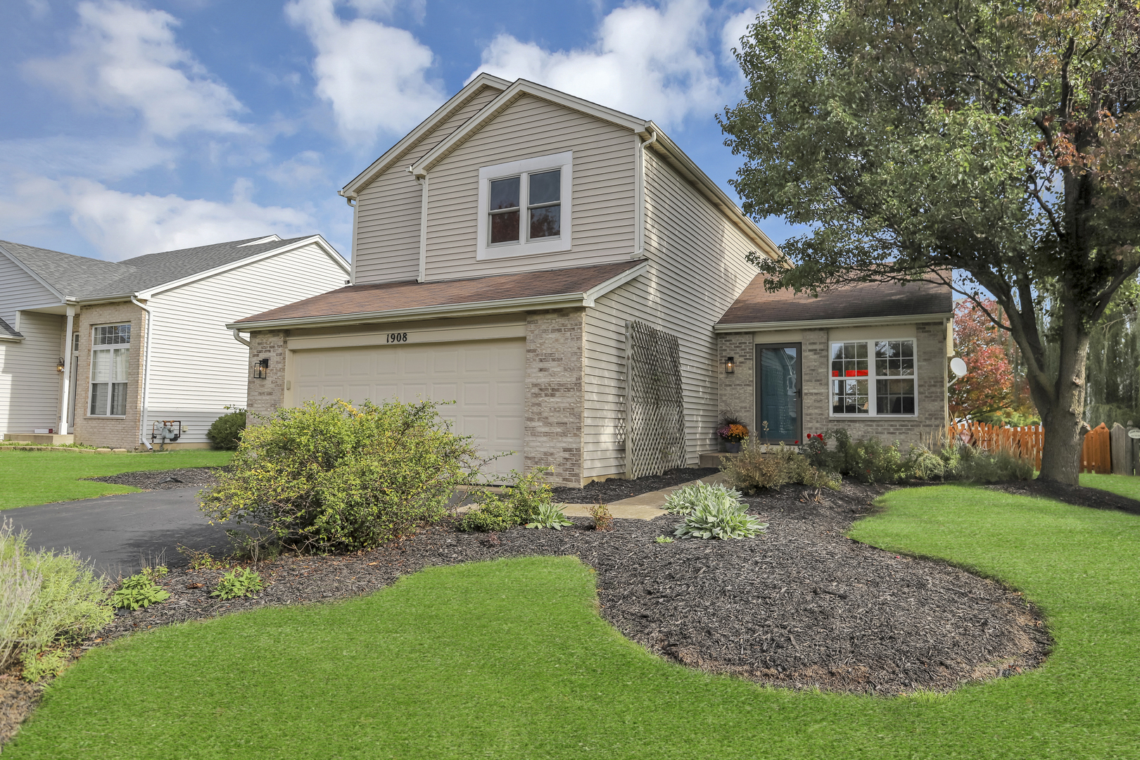 1908 Prairie Ridge Drive Plainfield, IL 60586 - Photo 1 of 34 a front view of a house with garden