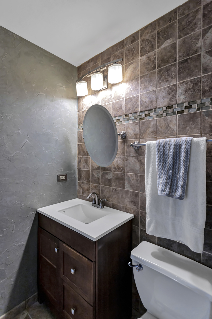 1908 Prairie Ridge Drive Plainfield, IL 60586 - Photo 19 of 34 a bathroom with a sink and a mirror
