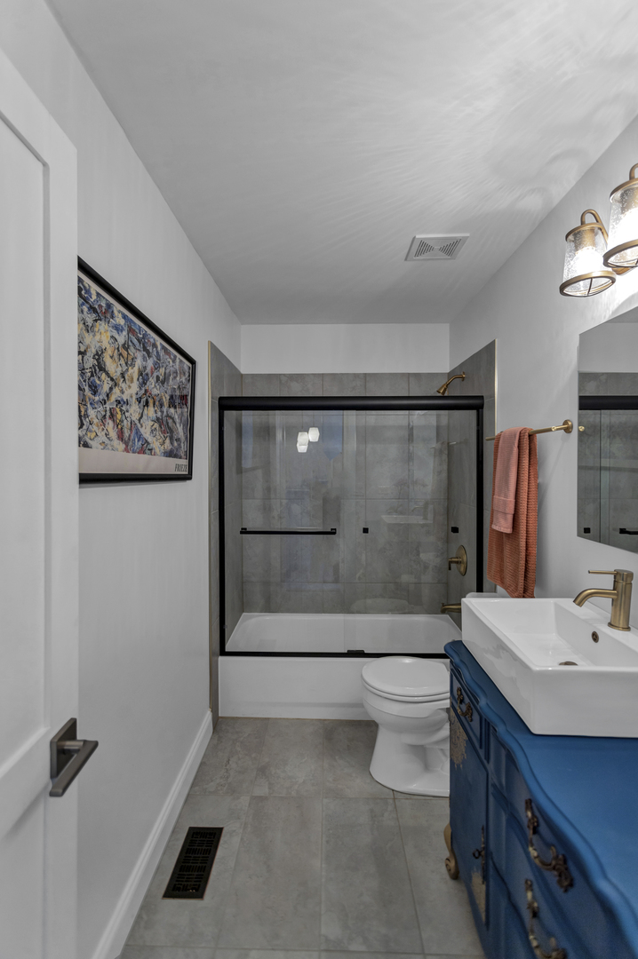 1908 Prairie Ridge Drive Plainfield, IL 60586 - Photo 24 of 34 a bathroom with a sink a toilet and shower