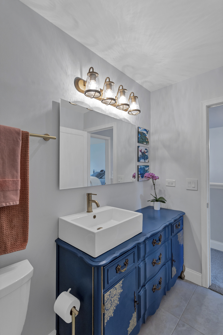 1908 Prairie Ridge Drive Plainfield, IL 60586 - Photo 25 of 34 a bathroom with a sink and a mirror