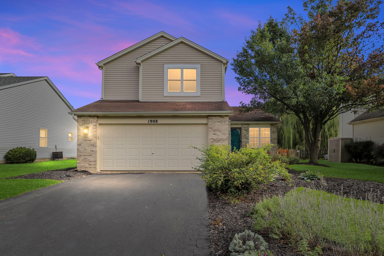 1908 Prairie Ridge Drive Plainfield, IL 60586 - Photo 34 of 34 a front view of a house with a yard and garage