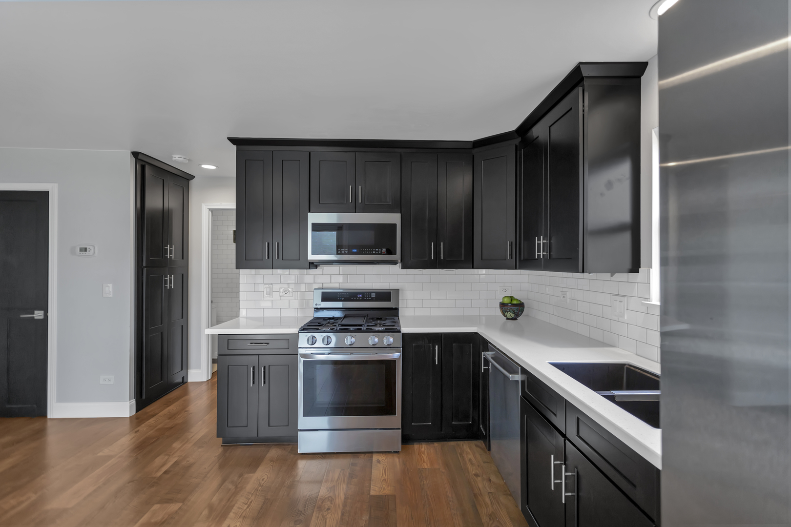 1908 Prairie Ridge Drive Plainfield, IL 60586 - Photo 6 of 34 a kitchen with a stove and a microwave