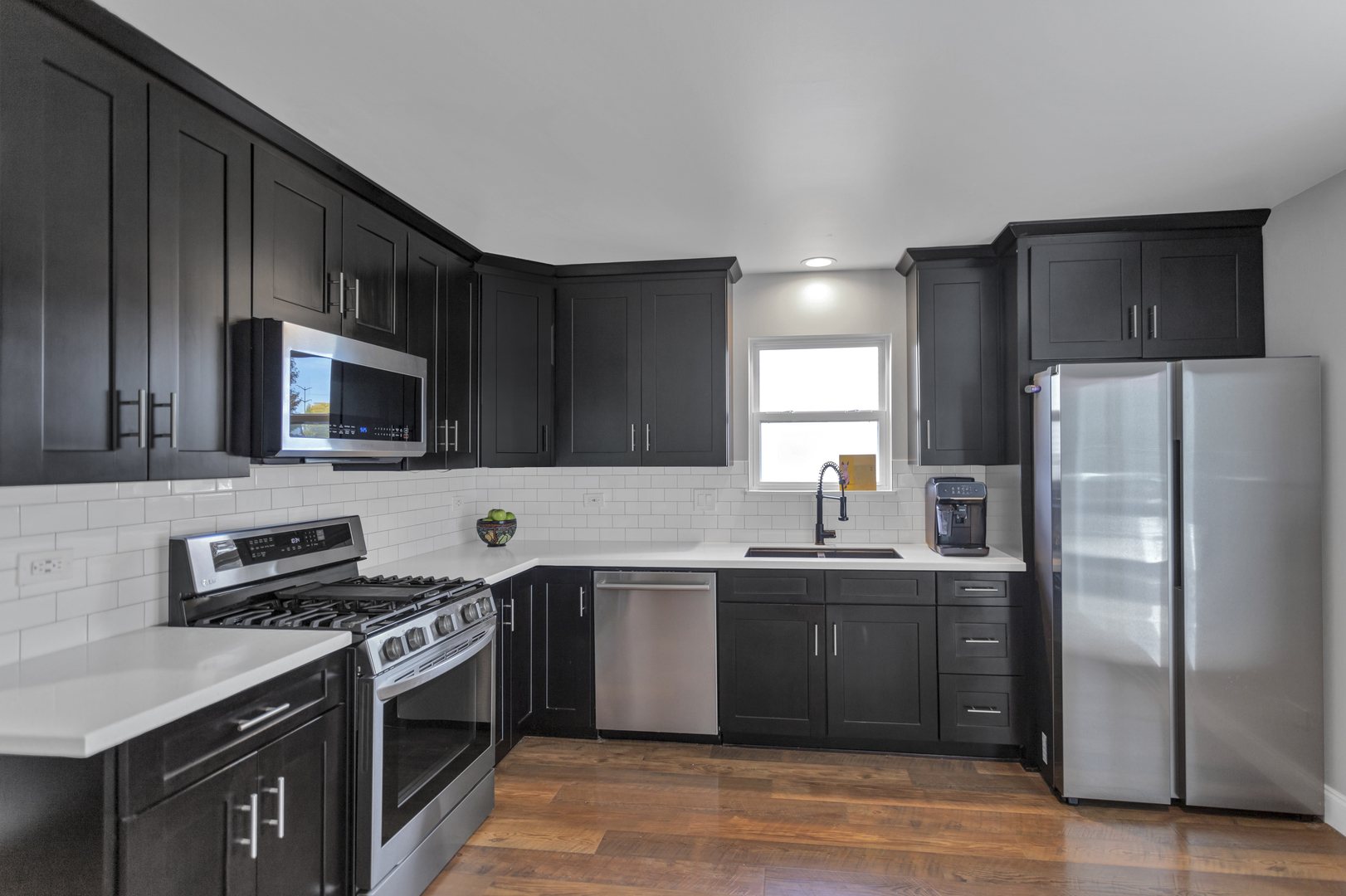 1908 Prairie Ridge Drive Plainfield, IL 60586 - Photo 7 of 34 a kitchen with stainless steel appliances a sink stove and refrigerator