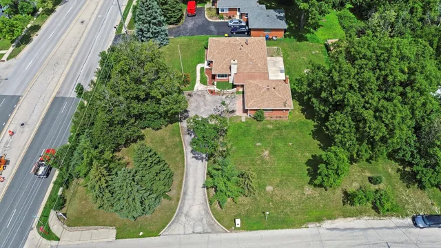 an aerial view of a house with garden space and street view