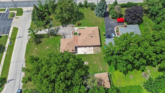 an aerial view of a house with a yard