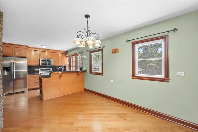 a view of a kitchen with stainless steel appliances granite countertop a stove and a refrigerator