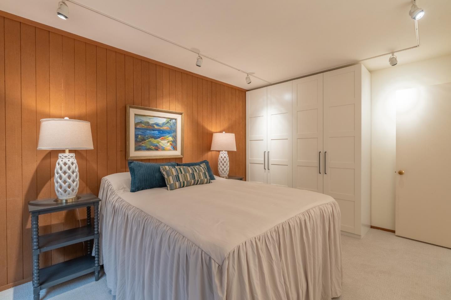 46 Middle Canyon Road Carmel Valley, CA 93924 - Photo 30 of 74 a bedroom with a bed and a lamp