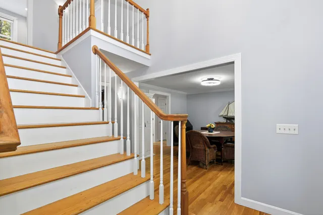 a view of entryway and hall with wooden floor