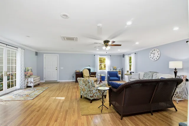 a living room with furniture and a wooden floor