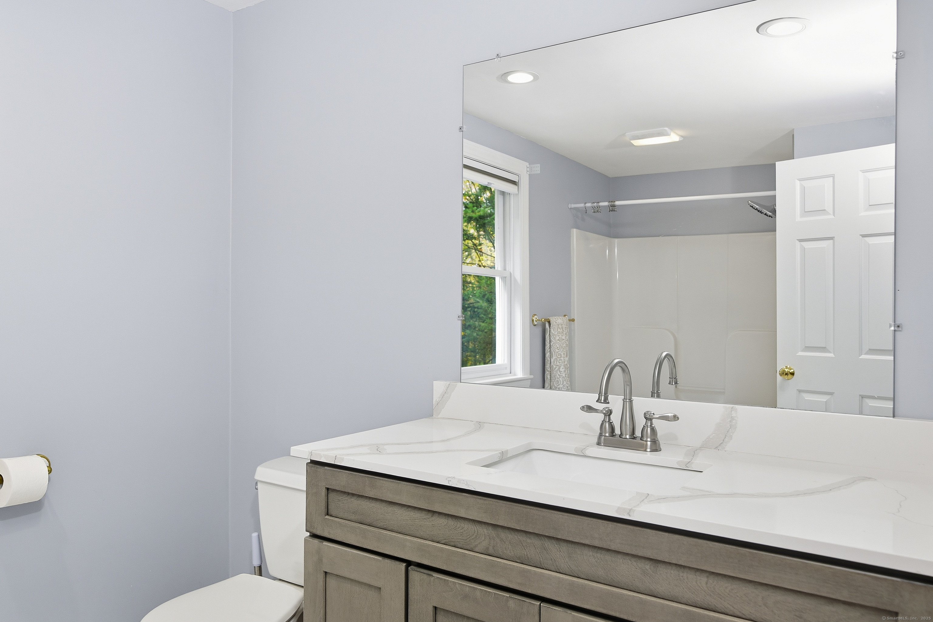 26 Center Road Woodstock, CT 06281 - Photo 18 of 39 a bathroom with a granite countertop sink a toilet and a mirror