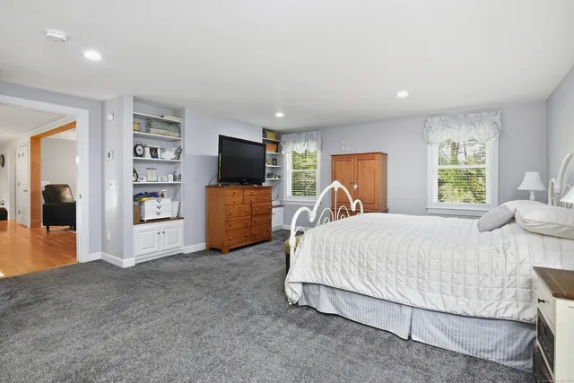 a bed room with a bed and a television