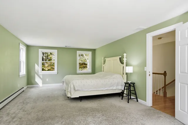 a bedroom with a bed and a painting on the wall