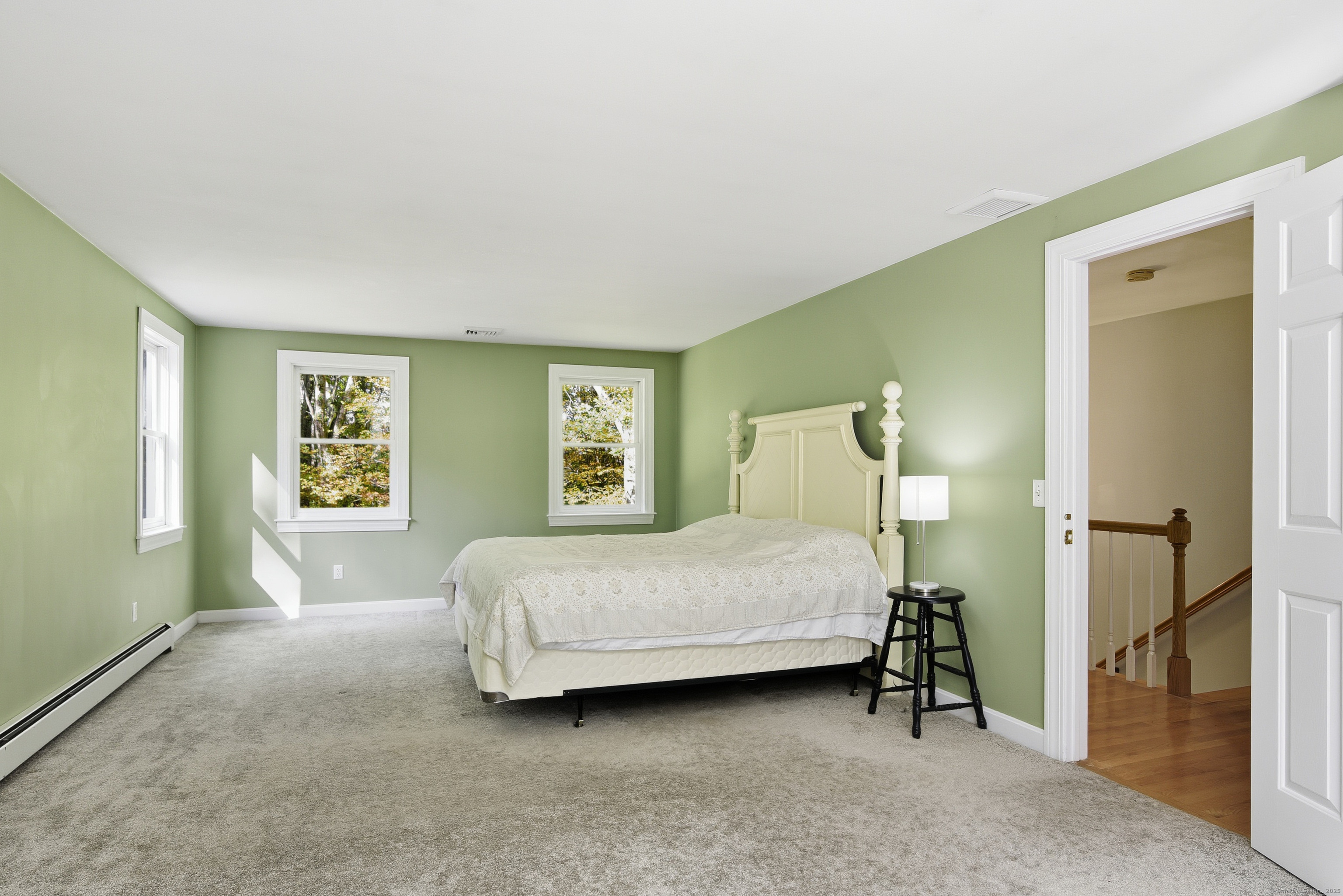 26 Center Road Woodstock, CT 06281 - Photo 23 of 39 a bedroom with a bed and a painting on the wall
