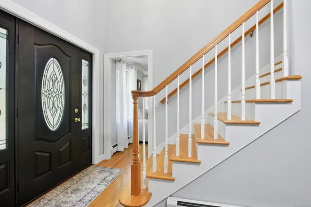 a view of staircase with wooden floor and a potted plant