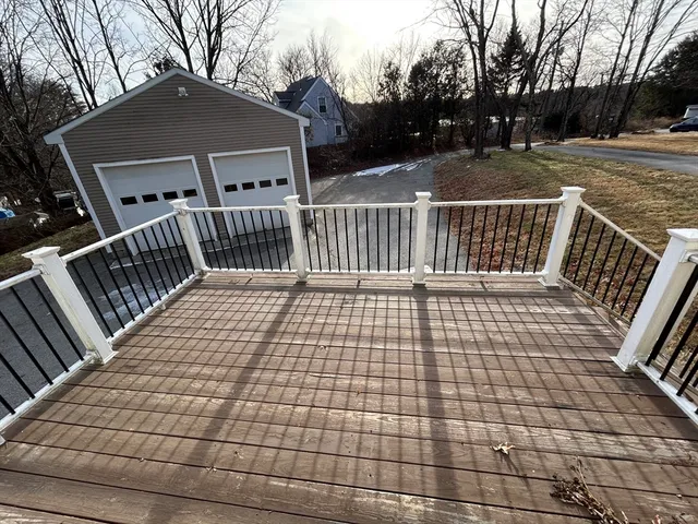 a view of a brick house with wooden fence