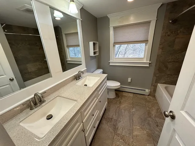 a bathroom with a sink mirror and a bath tub