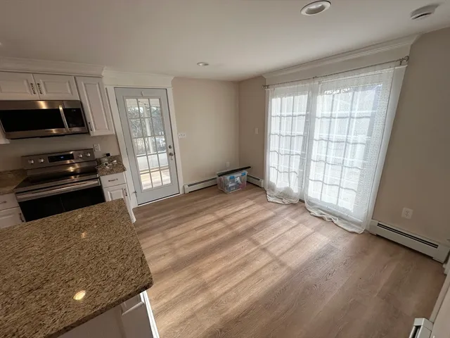 a kitchen with a stove a sink and a window