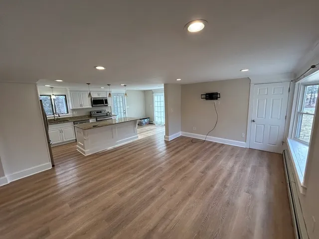 a view of kitchen with wooden floor and window