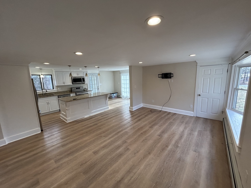256 Old Webster Road, Unit 1 Oxford, MA 01540 - Photo 7 of 19 a view of kitchen with wooden floor and window