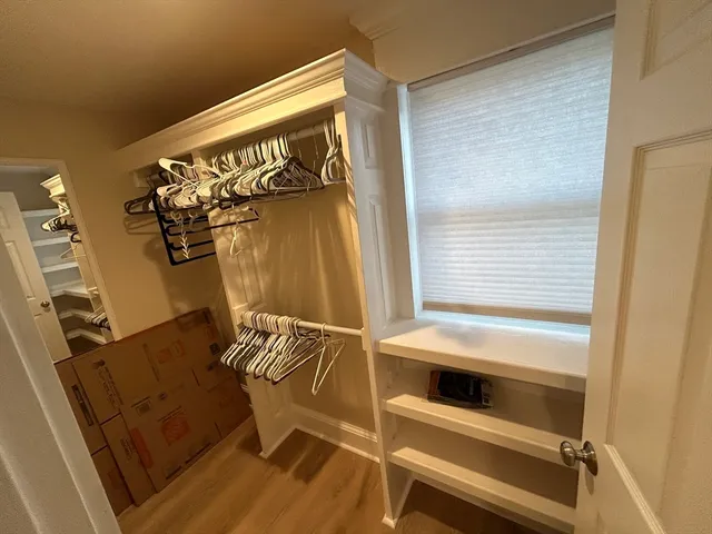 a view of walk in closet with empty racks