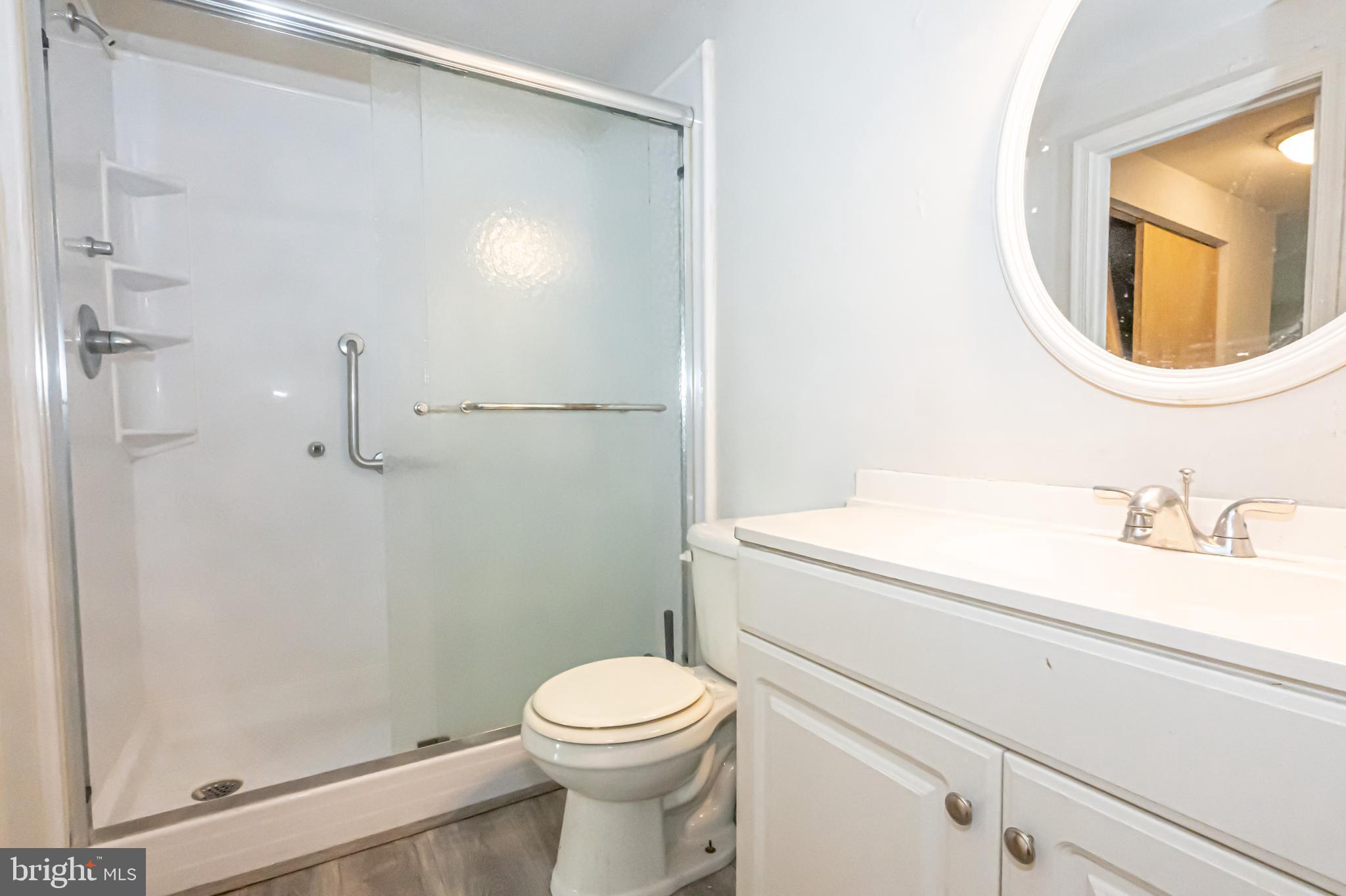 2637 Rooks Head Place Waldorf, MD 20602 - Photo 11 of 18 a bathroom with a toilet a sink and a mirror