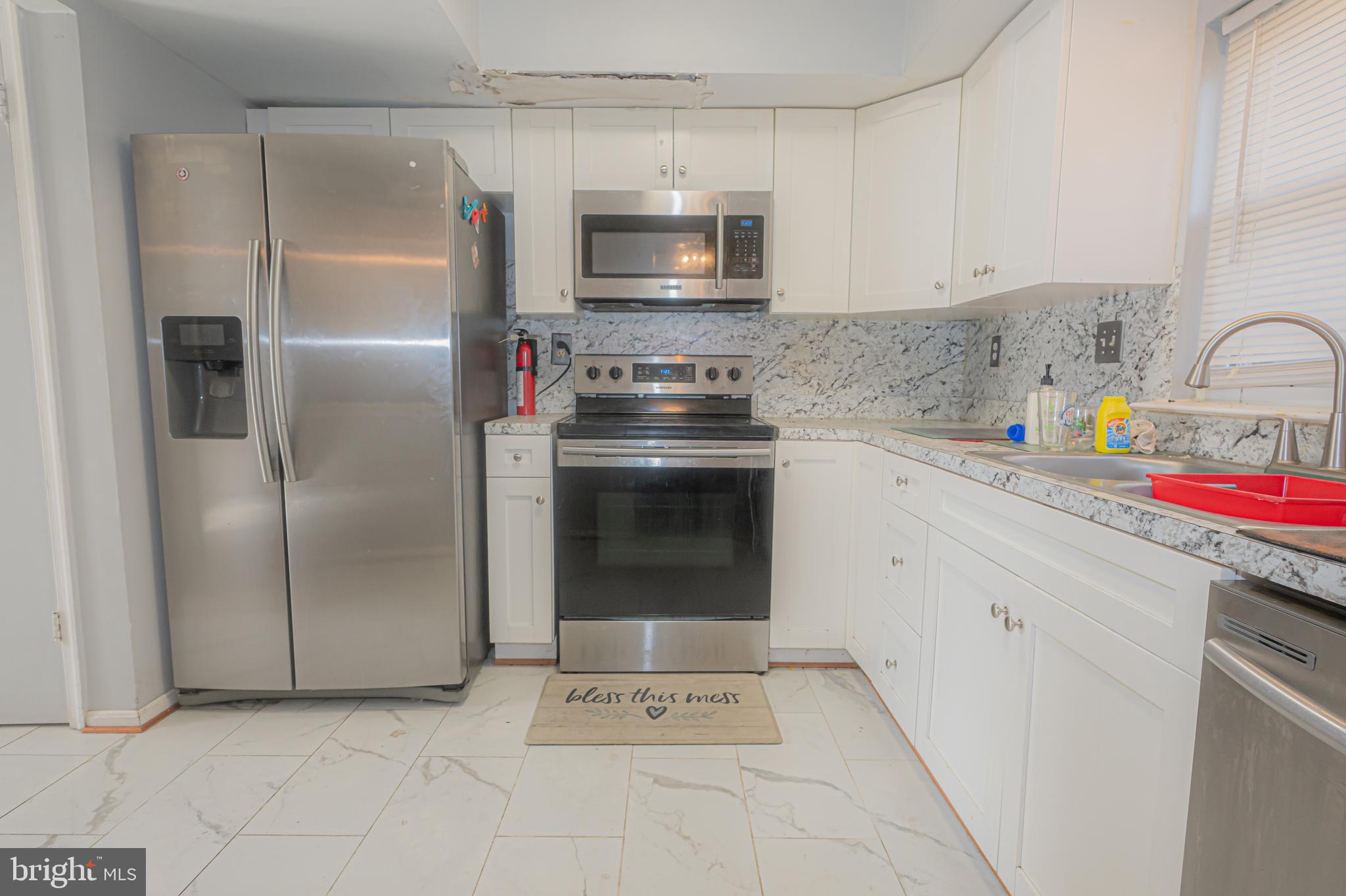 2637 Rooks Head Place Waldorf, MD 20602 - Photo 4 of 18 a kitchen with cabinets and stainless steel appliances
