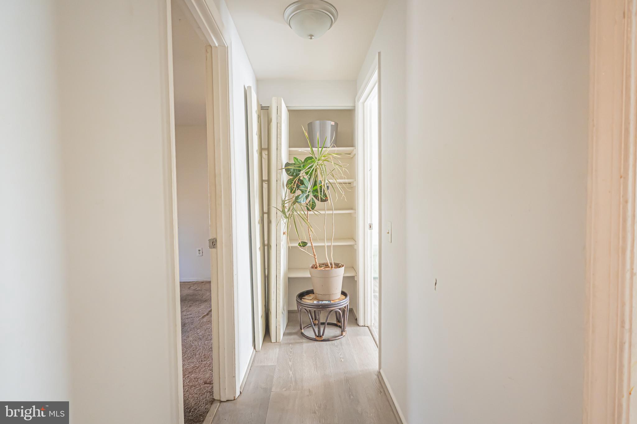 2637 Rooks Head Place Waldorf, MD 20602 - Photo 10 of 18 a view of a hallway with bathroom and wooden floor
