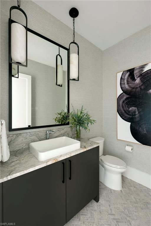 6704 Newport Road Naples, FL 34109 - Photo 15 of 47 a bathroom with a sink toilet and mirror