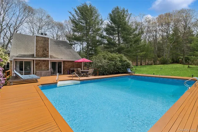 a view of a chairs and table in backyard