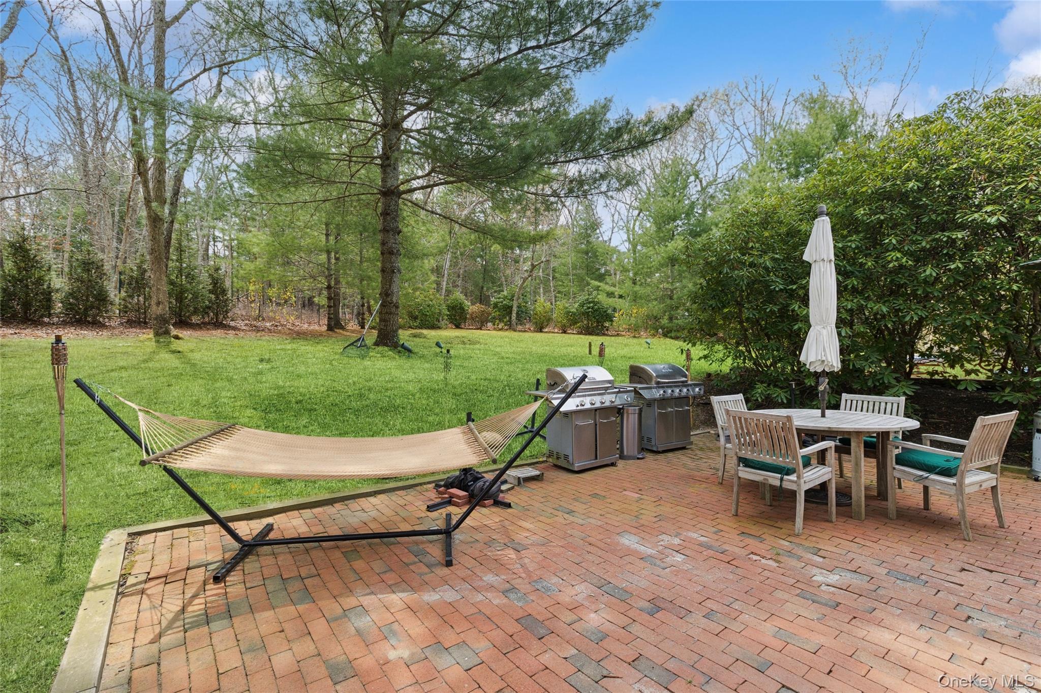 27 Ely Brook Road East Hampton, NY 11937 - Photo 20 of 50 View of patio with area for grilling and outdoor dining area
