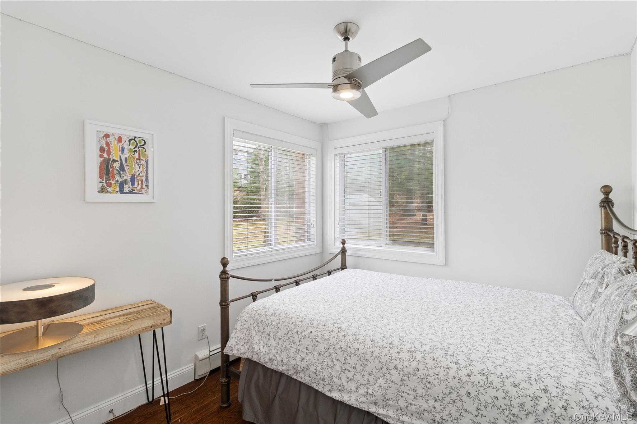 27 Ely Brook Road East Hampton, NY 11937 - Photo 23 of 50 Bedroom with baseboard heating, baseboards, a ceiling fan, and dark wood-type flooring