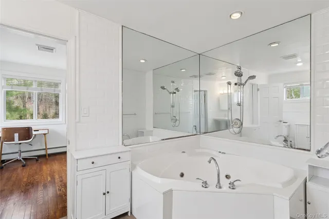 a bedroom with a bed a lamp and a large window