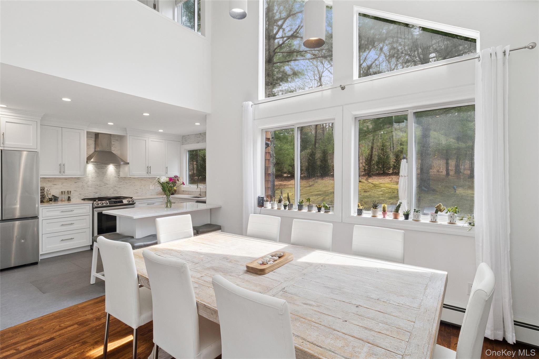27 Ely Brook Road East Hampton, NY 11937 - Photo 8 of 50 Dining space featuring recessed lighting, a high ceiling, and baseboard heating