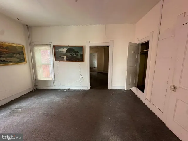 a view of a livingroom with an empty space and a window