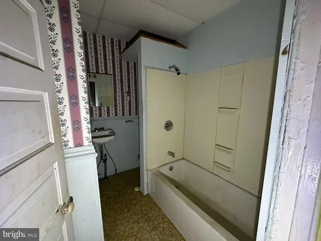 a bathroom with a tub and a sink