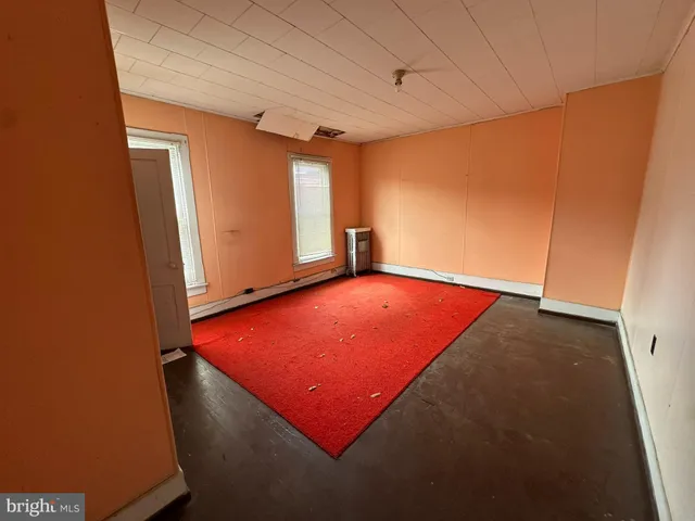 a room with pool table and windows