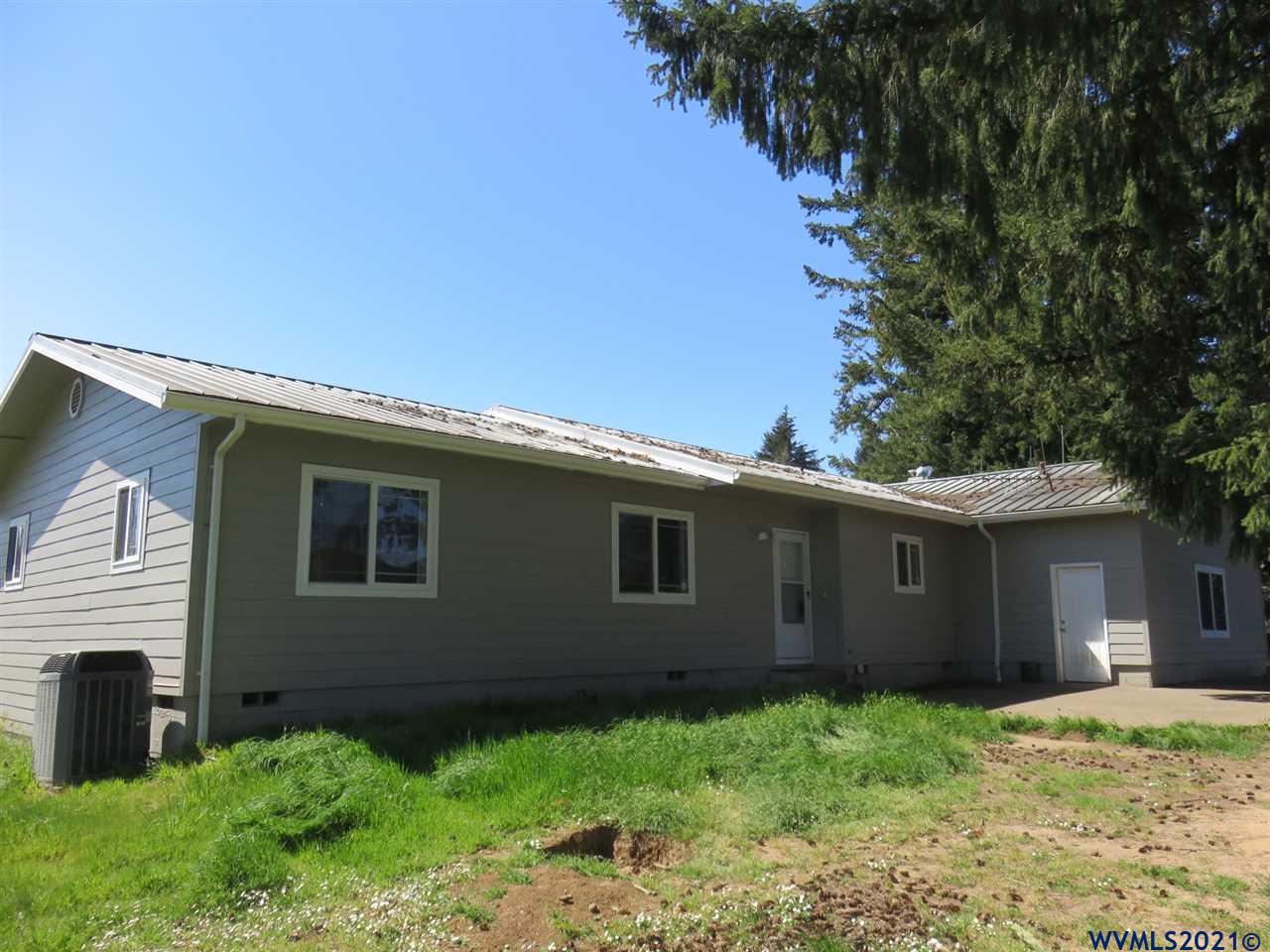 18990 Falls City Road Dallas, OR 97338 - Photo 1 of 42 a backyard of a house with plants and garden