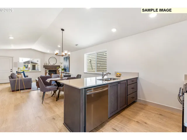 a kitchen with stainless steel appliances granite countertop a sink dishwasher a stove with wooden floor