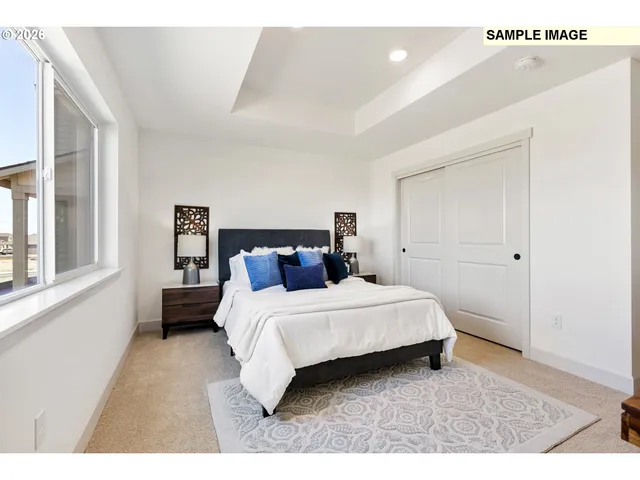 a bedroom with a bed and a large window