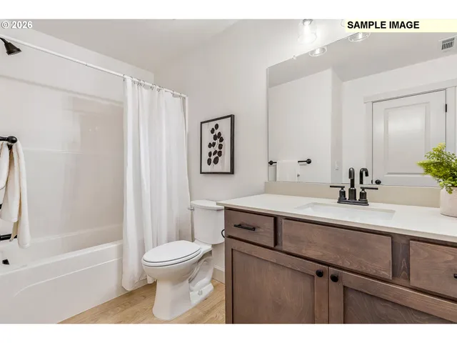 a bathroom with a sink a toilet and a large mirror
