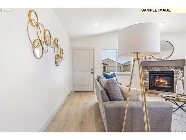 a living room with furniture a fireplace and a window