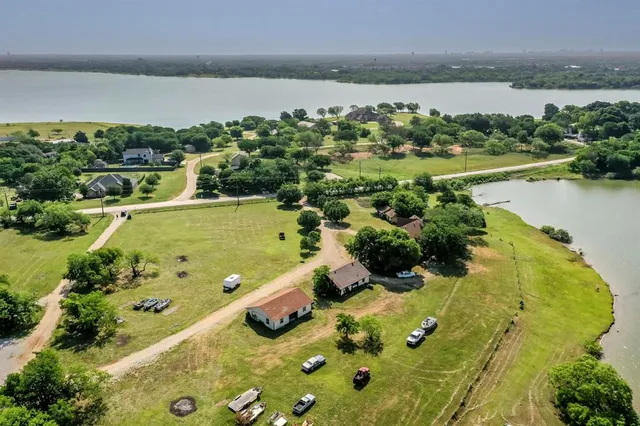 an aerial view of a house with a lake view